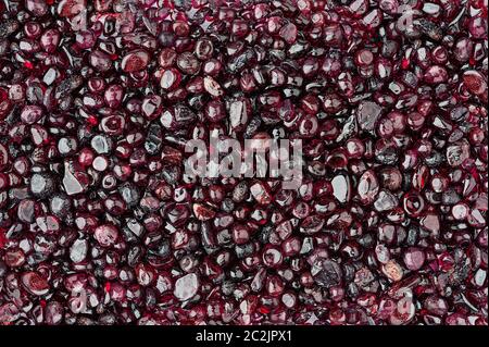 Small rounded garnet stones textured background Stock Photo