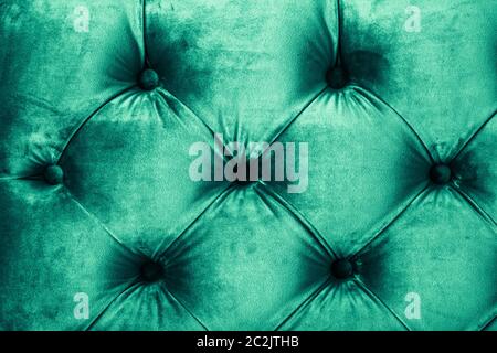 Emerald luxury velour quilted sofa upholstery with buttons, elegant green home decor texture and background Stock Photo