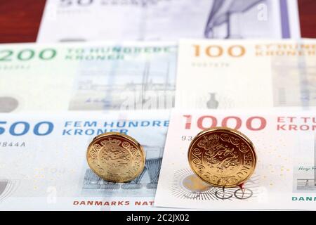 Danish coins on the background of banknotes Stock Photo