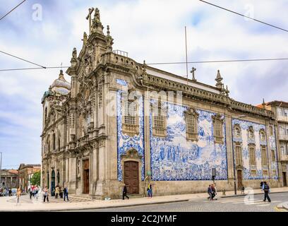 Porto Portugal - May 30, 2018: 18th century Igreja do Carmo Church of Carmelites with ornate tiled side facade decorated with Portuguese azulejo tiles Stock Photo