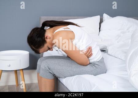 Close-up Of A Woman Suffering From Stomach Pain Stock Photo