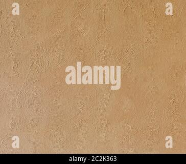 Bright beige rough plastered house wall frame as a background Stock Photo