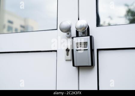 Key Safe Hanging On The Door With Keys Securely Stored Inside Stock Photo
