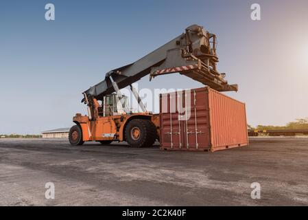 Forklift handling container box loading at the Docks with Truck Stock Photo