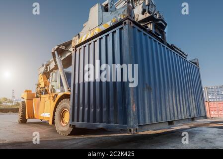 forklift handling container box loading from dock to truck Stock Photo