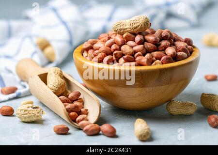 Organic peanuts in a wooden bowl. Stock Photo