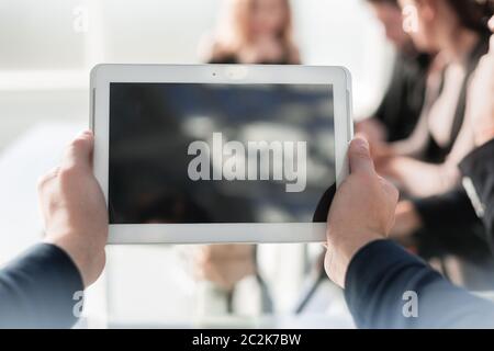 Hands holding blank vertical tablet mock up. Stock Photo
