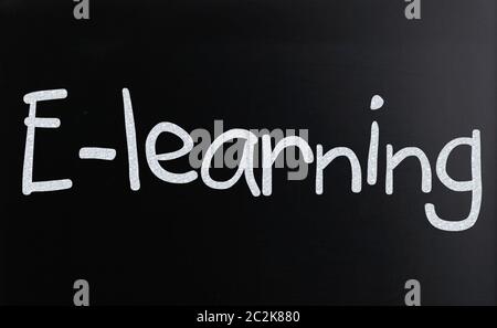 The word E-learning handwritten with white chalk on a blackboard Stock Photo