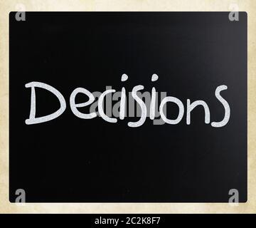 The word Decisions handwritten with white chalk on a blackboard Stock Photo