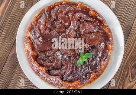 Whole Tarte Tatin decorated with fresh mint: top view Stock Photo