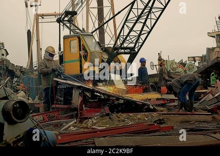 Men working on a ship-breaking yard in Cilincing, North Jakarta, Jakarta, Indonesia. Archival photo. Stock Photo