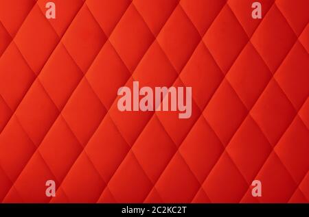 Background texture of scarlet red genuine leather soft tufted furniture or wall panel upholstery with deep diamond pattern, close up Stock Photo