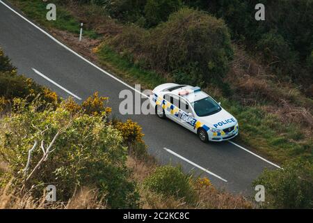 A New Zealand Police Holden Commodore VF Evoke patrol car parked on a road side at a crash scene in Christchurch, NZ