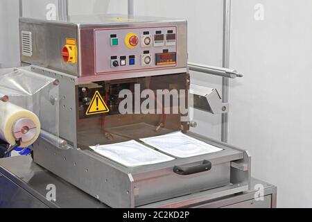 Automated Foil Packaging Machine in Food Factory Production Stock Photo