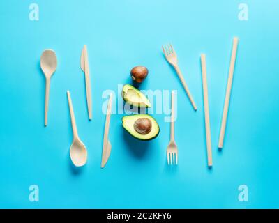 Avocado Seeds Biodegradable Single-Use Cutlery. Bioplastic - Great alternative to plastic disposable cutlery. Minimal concept on blue background. Stock Photo