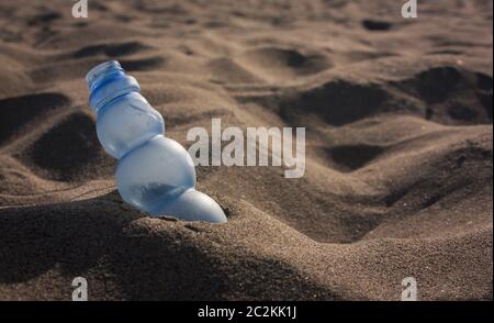 Pollution: a stranded Plastic waste on the sand of a beautiful Italian beach Stock Photo