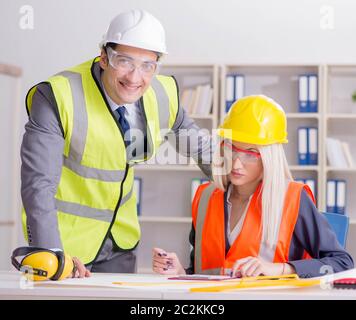 Construction workers having discussion in office before starting project Stock Photo