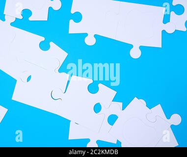 empty white big puzzles on a blue background. Concept in business Stock Photo