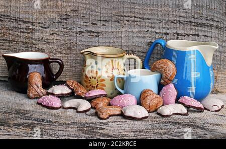 Colourful gingerbread and old coffee pots on a wooden background Stock Photo