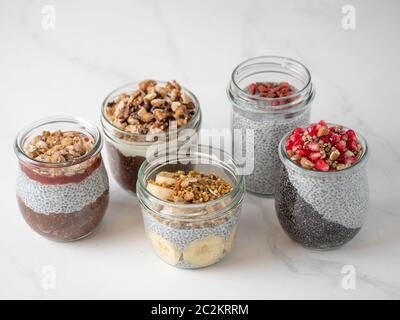 chia pudding set in different glass jars Stock Photo
