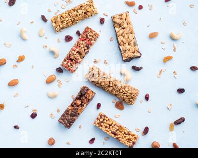 Set of different granola bars on blue background Stock Photo