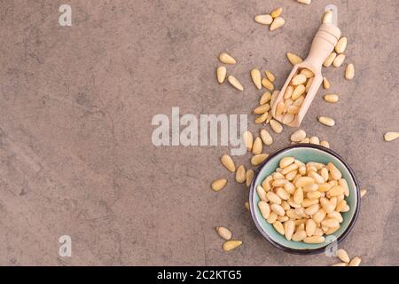 Pine Nuts On A Brown Textured Background, Close Up Stock Photo - Alamy