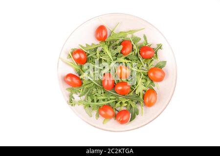 Cherry tomatoes and arugula leaves isolated on a white background Stock Photo