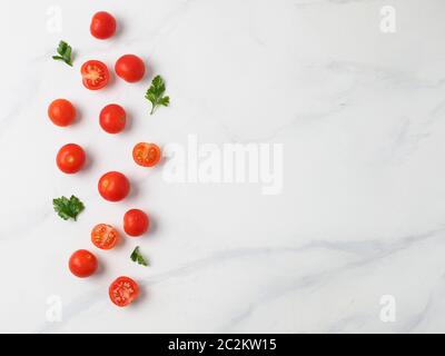 Cherry tomatoes on white marble table Stock Photo