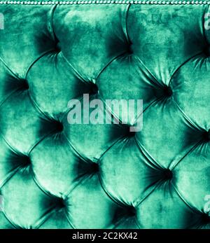 Emerald luxury velour quilted sofa upholstery with buttons, elegant green home decor texture and background Stock Photo