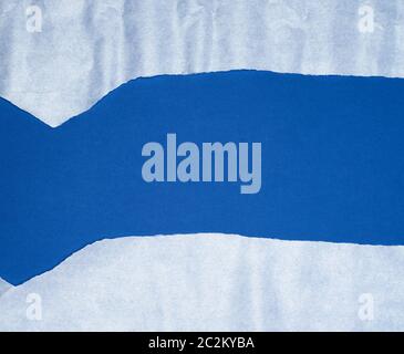 blue background with white crumpled torn paper elements, place for writing op in the middle, template Stock Photo