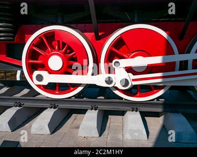 Red wheels of an old railway locomotive. Retro transport. Transport. Stock Photo