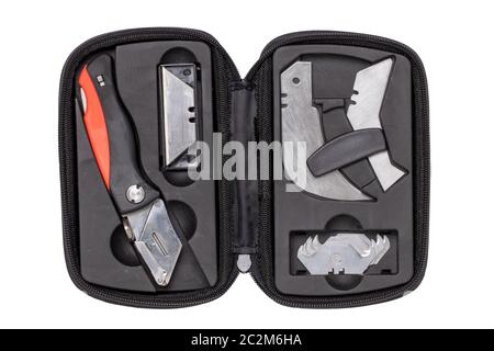 Closeup of an industrial knife for cutting carpets and flooring with various very sharp blades in a opened black bag isolated on a white background. M Stock Photo