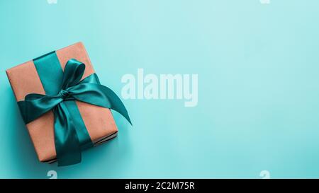 Gift box in craft paper and satin ribbon Stock Photo