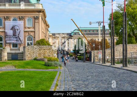 Tourists including several young women leave the Royal Palace museum and art exhibit, part of the Buda Castle Complex in Budapest, Hungary Stock Photo