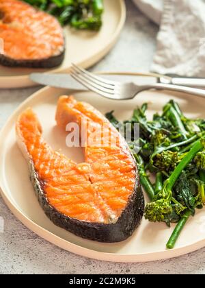Ready-to-eat grilled salmon steak and greens Stock Photo