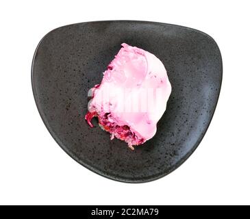 top view of portion of Dressed herring russian salad on black plate isolated on white background Stock Photo