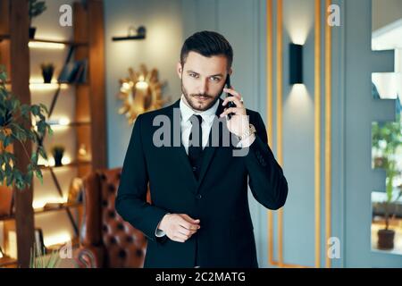 Young handsome businessman talking on mobile phone Stock Photo