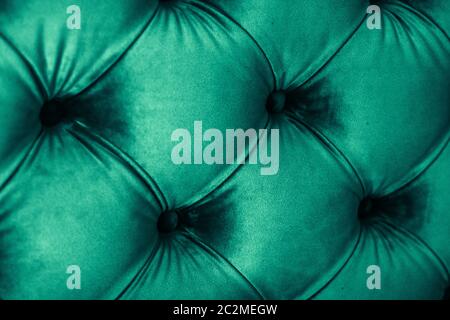 Emerald luxury velour quilted sofa upholstery with buttons, elegant green home decor texture and background Stock Photo