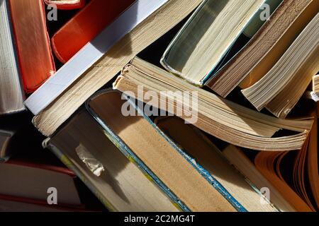 Messy oile of old books in the attic Stock Photo