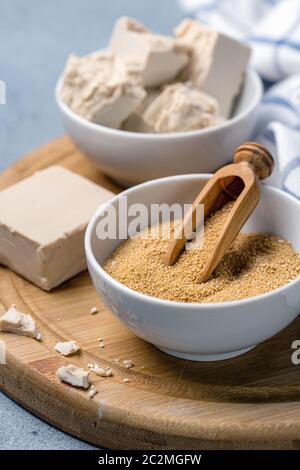 Dry and pressed yeast in ceramic bowls. Stock Photo