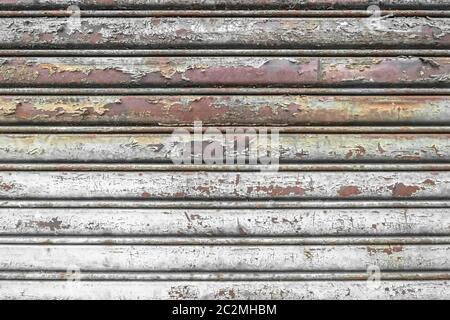 Old corrugated metal texture with rust spots on surface and peeled-off paint. Stock Photo