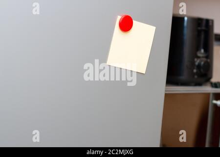 blank sticky note with red pin on fridge, close up Stock Photo