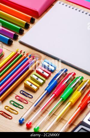Bright stationery goods at the showcase in the store. School objects for students. On a wooden background. flat lay. copyspace Stock Photo