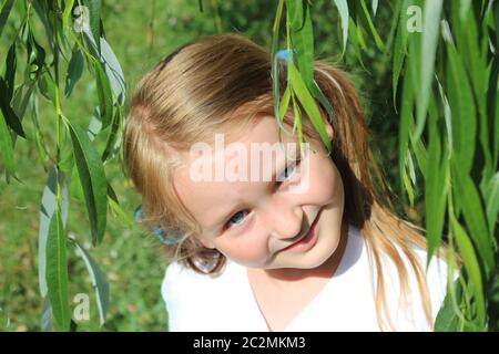 Portrait of little pretty girl make an air kiss. Beautiful girl with long  dark blonde hair and wonderful expressive brown eyes. Little lady  schoolgirl Stock Photo - Alamy