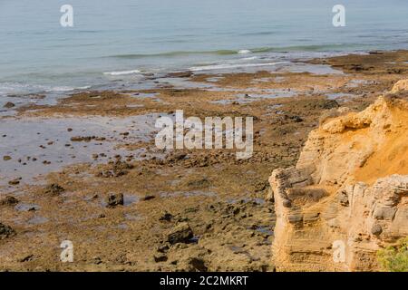 ALBUFEIRA, PORTUGAL - AUGUST 23, 2017: People at the famous beach of Olhos de Agua in Albufeira. This beach is a part of famous tourist region of Alga Stock Photo