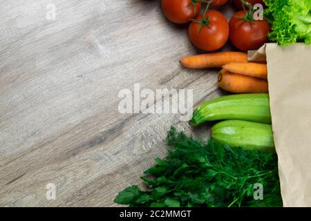 Many different vegetables including beets, cabbage, zucchini, carrots, tomatoes, peppers and cucumbers on a wooden background. top view with clear spa Stock Photo