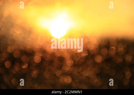 Golden sunset through window. Bright bokeh. Golden bokeh. Texture with gold abstraction Stock Photo