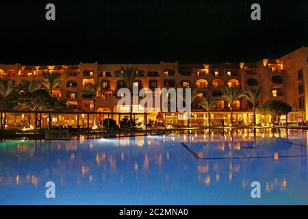Hurghada / Egypt. 28 July 2018: Lights of evening hotel are reflected in pool water in night Stock Photo