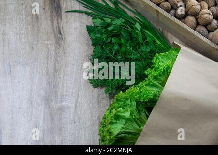 Background of Various Fresh Greens with Lettuce, Basil, nuts, Dill and Parsley. Top views with clear space Stock Photo