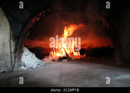 Fire wood brighly burning in furnace. Firewood burn in rural oven. Burning firewood in fireplace Stock Photo